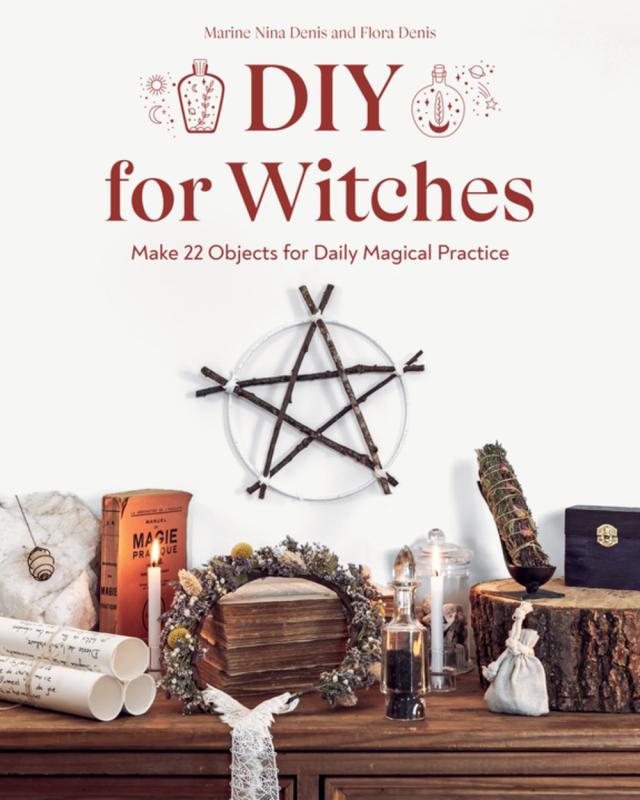 a pentagram, some scrolls, candles, a book, and a stump