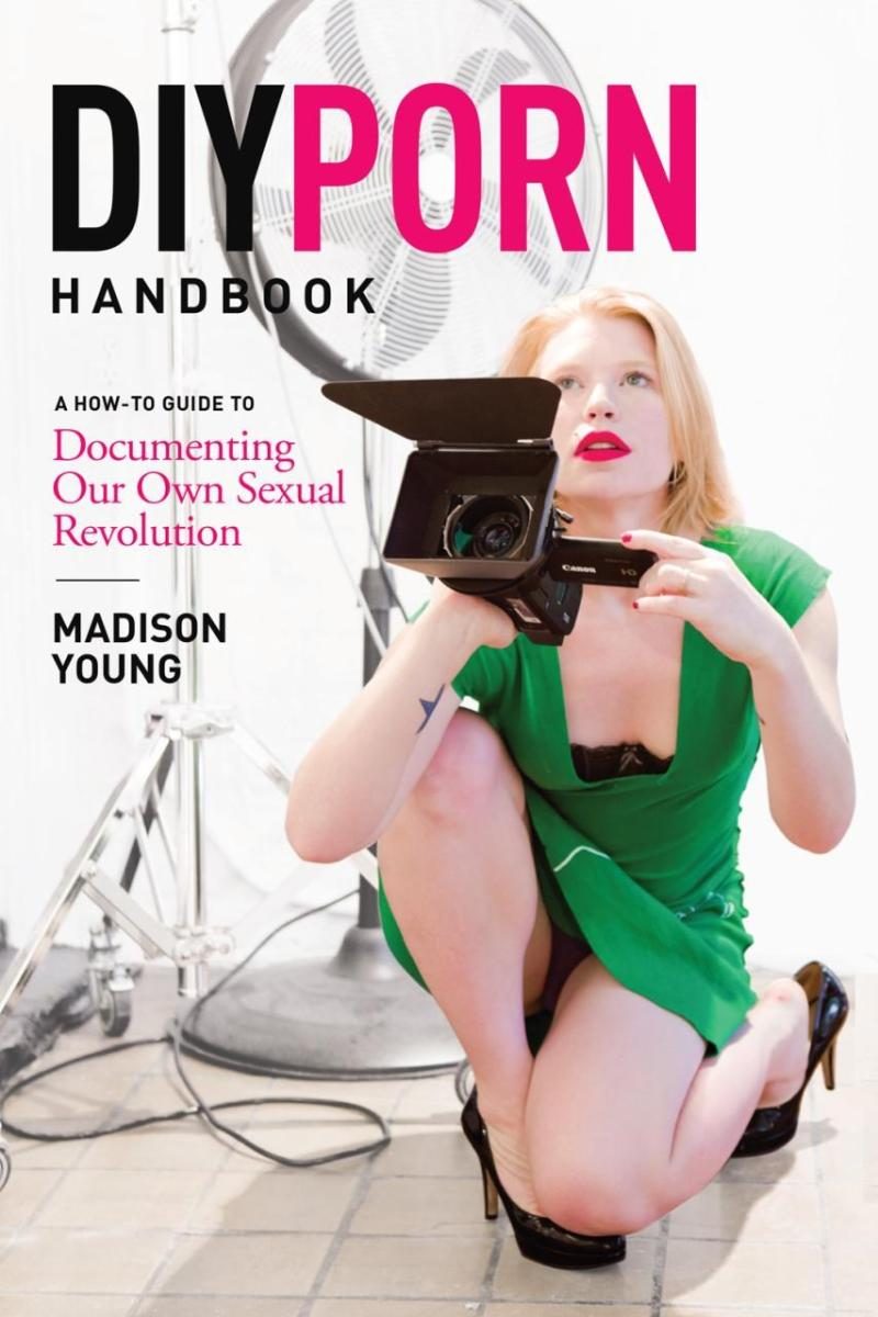 person in green dress holding a movie camera with black and pink text