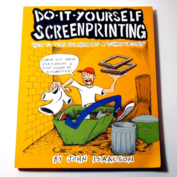 A yellow book with a cartoon of a man running from a dumpster with a t-shirt and silk screens in his hands
