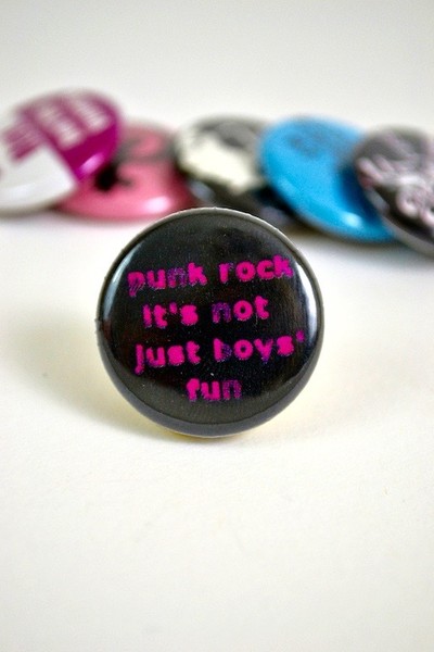 black button with hot pink text that reads "punk rock it's not just boy's fun"