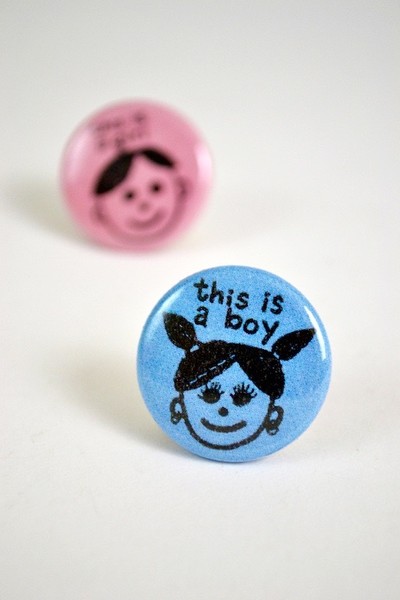 this is a boy button with person with pigtails