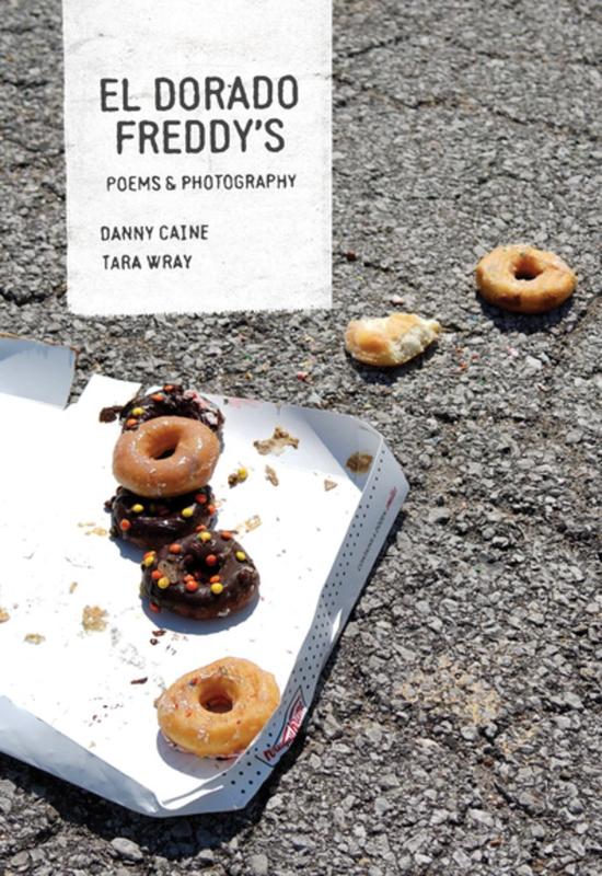 an open box of Krispy Kreme donuts dropped on a concrete road 