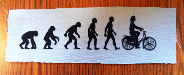 Bicycle evolution patch showing an ape evolving into an upright cyclist