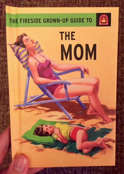 a white woman lounges in a beach chair, ignoring the child on a towel next to her