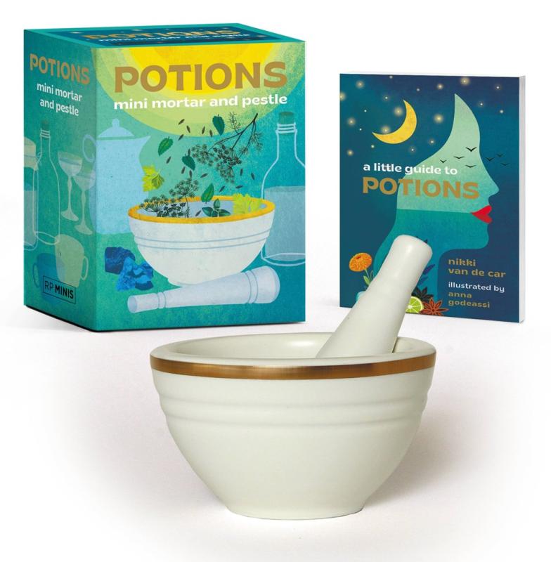 a small bowl and pestle with a book