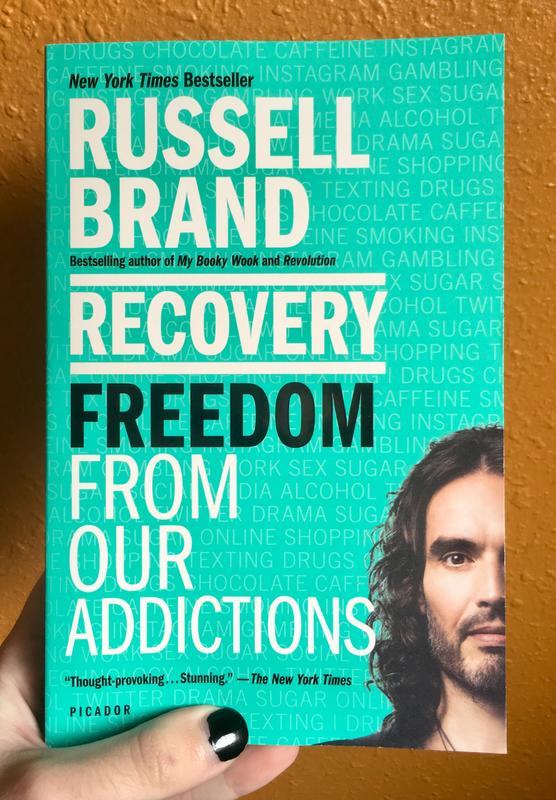 A teal cover with very pale text outlining all the things people can get addicted to. The author's photo is in the bottom right corner. 
