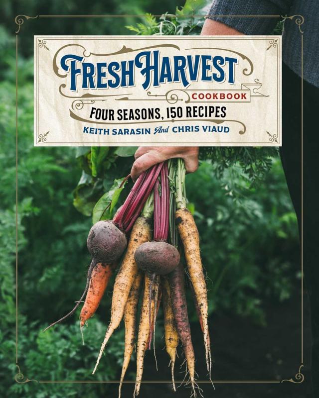 A gardener holds a handful of turnips and carrots and beets.