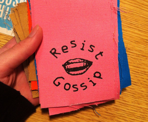 a canvas patch that says resist gossip with an image of lips