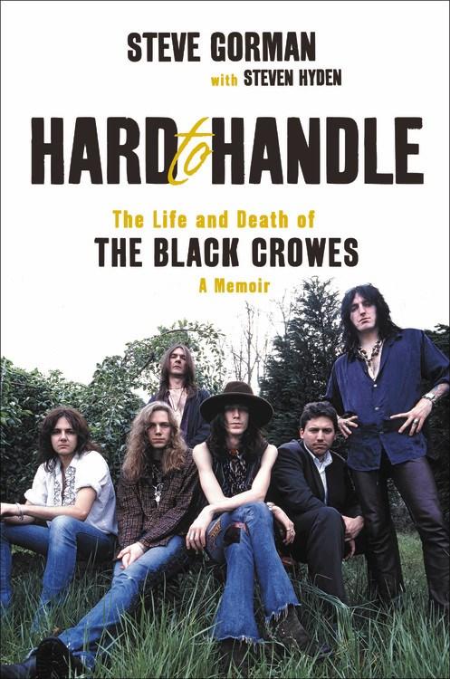 The members of The Black Crowes posing in a field
