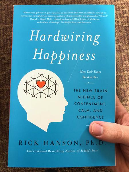 Blue paperback with white text titled Hardwiring Happiness