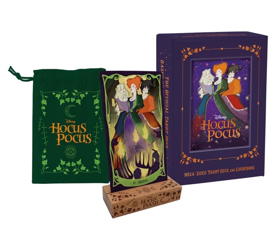 center; a tarot card of Justice featuring the 3 witches from Hocus Pocus, on a wooden stand. Left: A green back with the Hocus Pocus logo and greenery. Right: A deck box with the same image as on the card