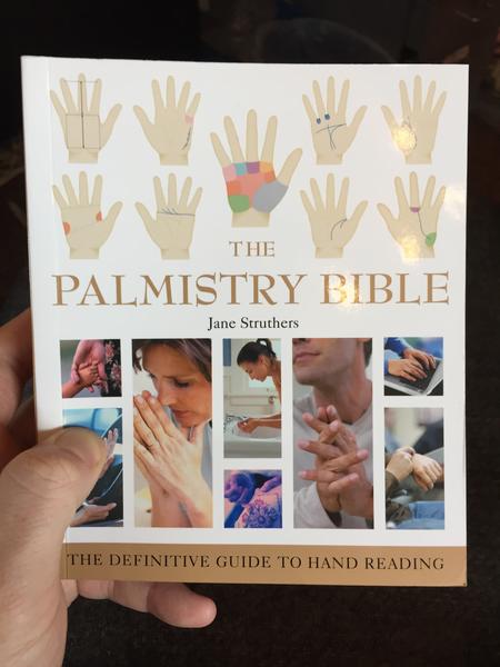 The Palmistry Bible: The Definitive Guide to Hand Reading by Jane Struthers (diagrams of hand lines and sections and photos of people using their hands for different things on a white background)