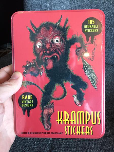 a red box with an illustration of Krampus holding a whip and chain.