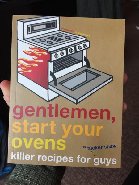 Gentlemen, Start Your Ovens: Killer Recipes for Guys by Tucker Shaw, photographs by Leigh Beisch [The cover is brown and there is an open oven with flames painted on the side]