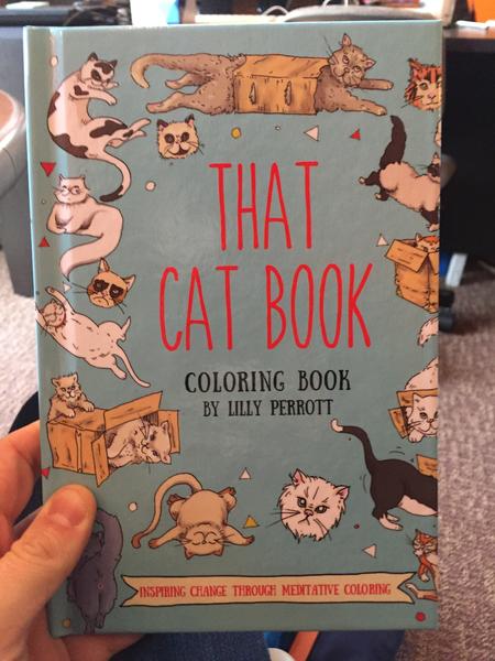 That Cat Book Coloring Book: Inspiring Change through Meditative Coloring by Lilly Perrott (a blue background with kitties, cats in boxes, and floating cat heads of all shapes, sizes, and colors)