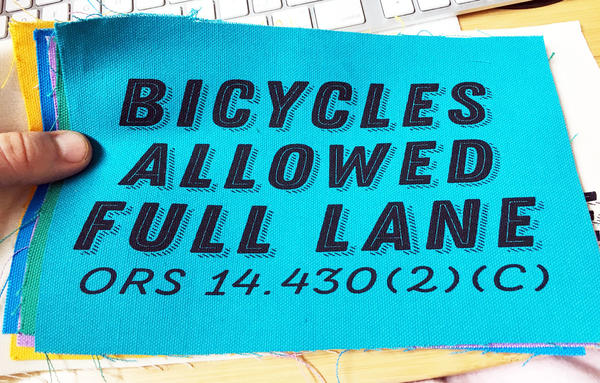 patch with text "bicycle allowed full lane"