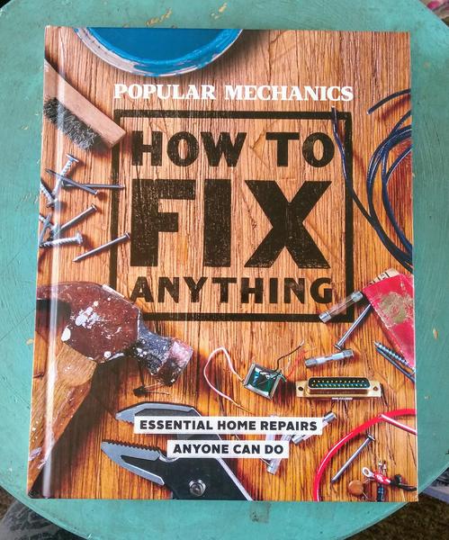 Cover of How to Fix Anything, which features a workbench covered in tools and other fix-it peripherals