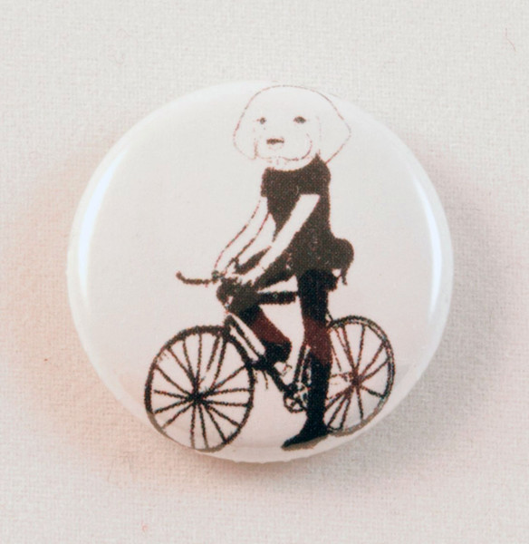 dog on a bicycle button