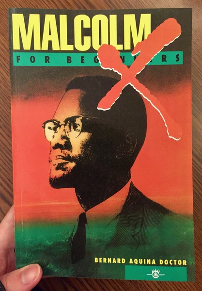 red background depicting Malcom X with a bright red X on right top of his head