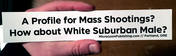 White sticker with black lettering stating: "a profile for mass shootings? How about White Suburban Male?"