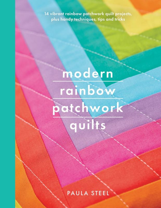 Cover shows a rainbow quilt.