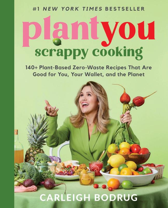 Green book cover featuring photograph of a woman dressed in green surrounded by fruit and vegetables.