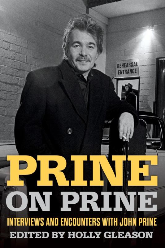 a black and white photo of john prine leaning against a rail, holding a cigarette