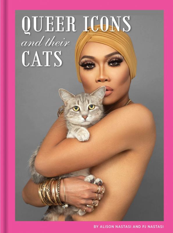 a drag queen hold her cats.
