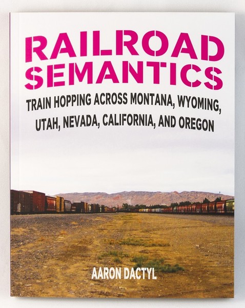 the cover of a book with an image of a train-yard and a mountain in the distance
