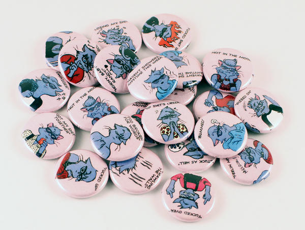 a pile of cat pins