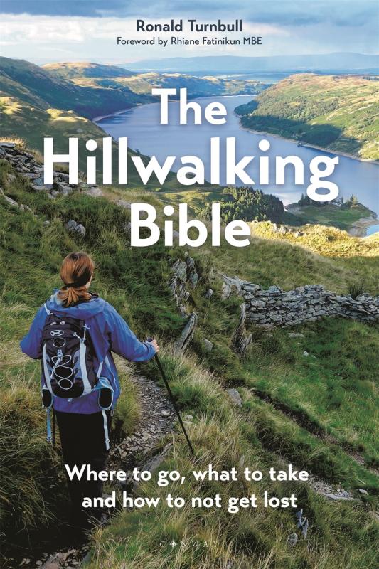 person hiking on a green hillside overlooking a river with white text