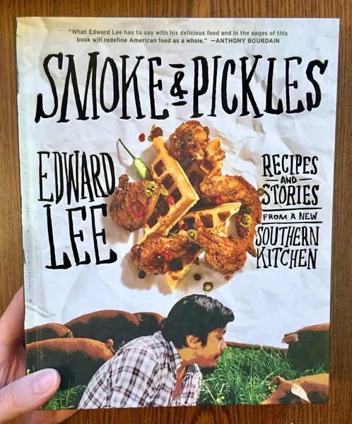 Smoke and Pickles: Recipes and Stories from a New Southern Kitchen [Meat and waffles hover in the center of the page, while Edward Lee looks through cows for his next meal]