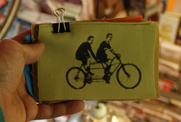 patch with image of two men riding tandem bicycle