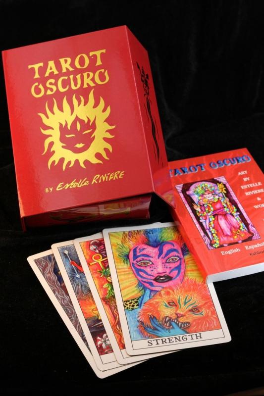 A photograph of the tarot card box, book, and four of the cards.