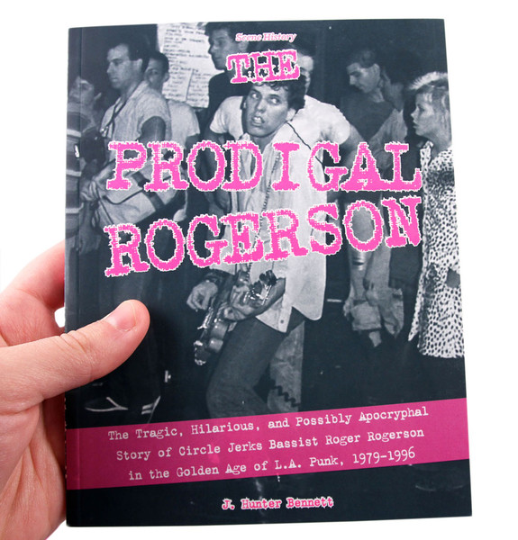 Prodigal Rogerson book cover: A punkish looking fellow plays guitar but appears to be thinking about something else entirely