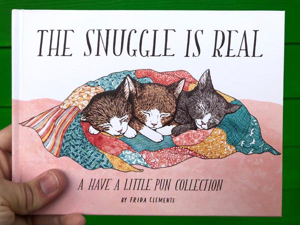 An illustration of three kittens cuddling under a blanket.