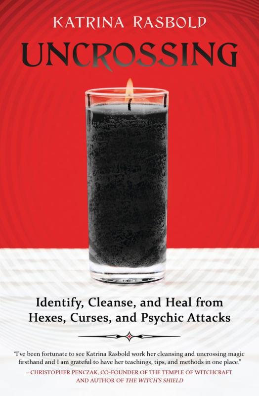 Black candle burning with red and white background.