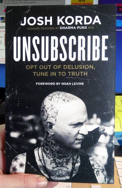 Unsubscribe by Josh Korda [A tattooed man stares to the side]