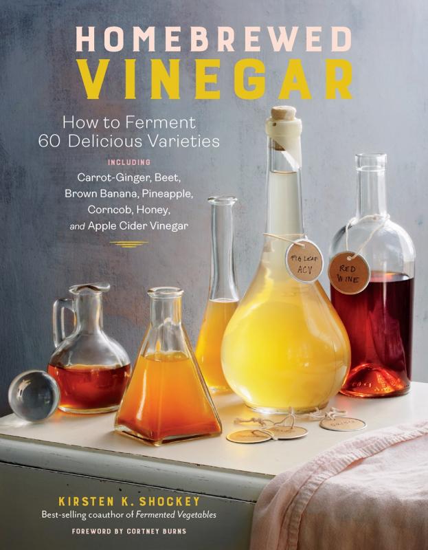 various vinegars in glass pitchers, vials, and containers