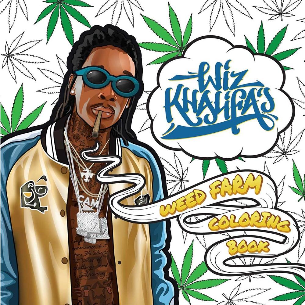 Wiz Khalifa stands in front of a backdrop of marijuana leaves