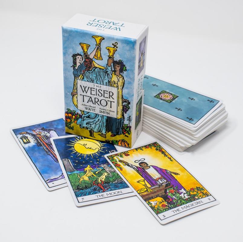 traditional tarot art in the style of the Waite deck on the deck box and on three cards lying by the deck box in the photograph