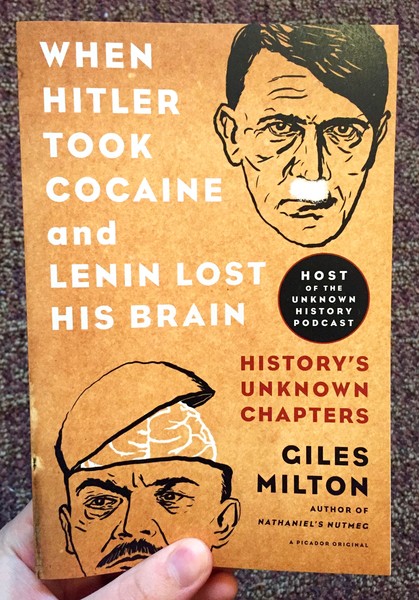 Hitler with cocaine under his nose and lenin with the top of his head lifted up, exposing his brain.