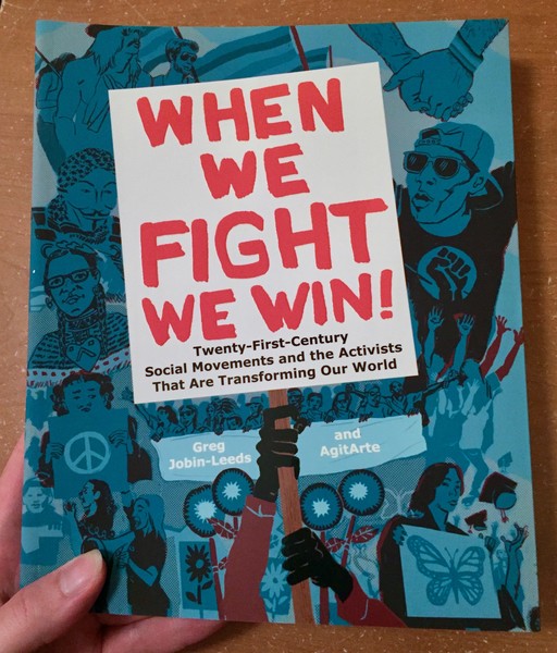 When We Fight We Win by Greg Jobin-Leeds and AgitArte [A resistance sign firmly clutched against a background of protesters]