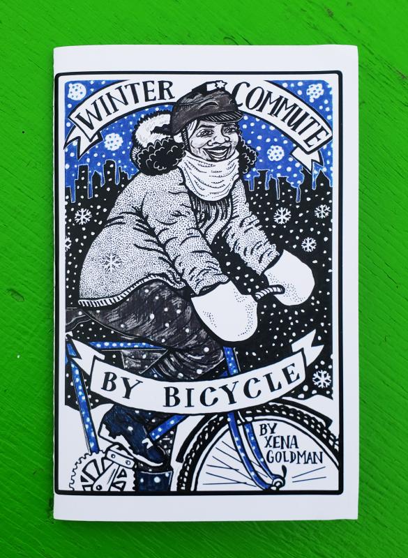 a woman decked out in winter clothing rides a bicycle in the snow