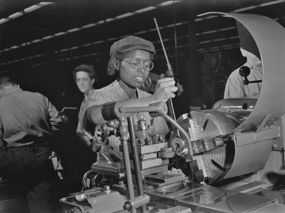 a woman works a lathe in WW2